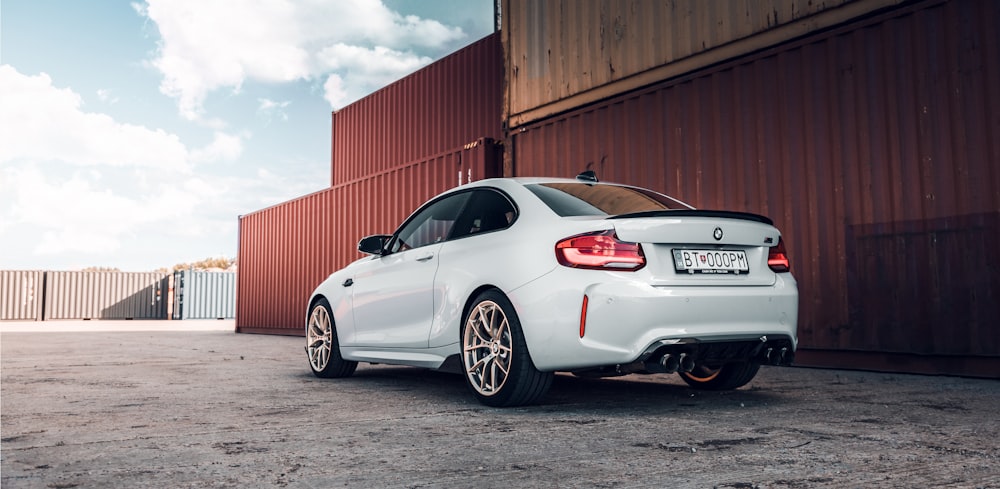 white bmw m 3 coupe parked near brown building