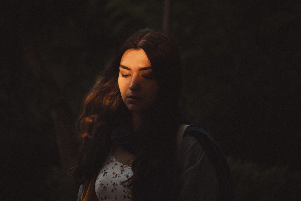 A person in a reflective moment in natural light
