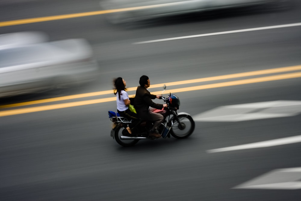man in blue jacket riding motorcycle on road during daytime
