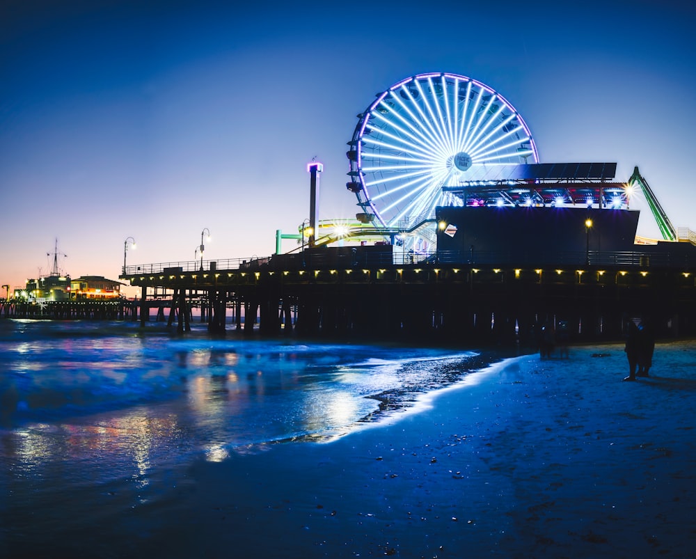 ferris wheel near body of water during night time