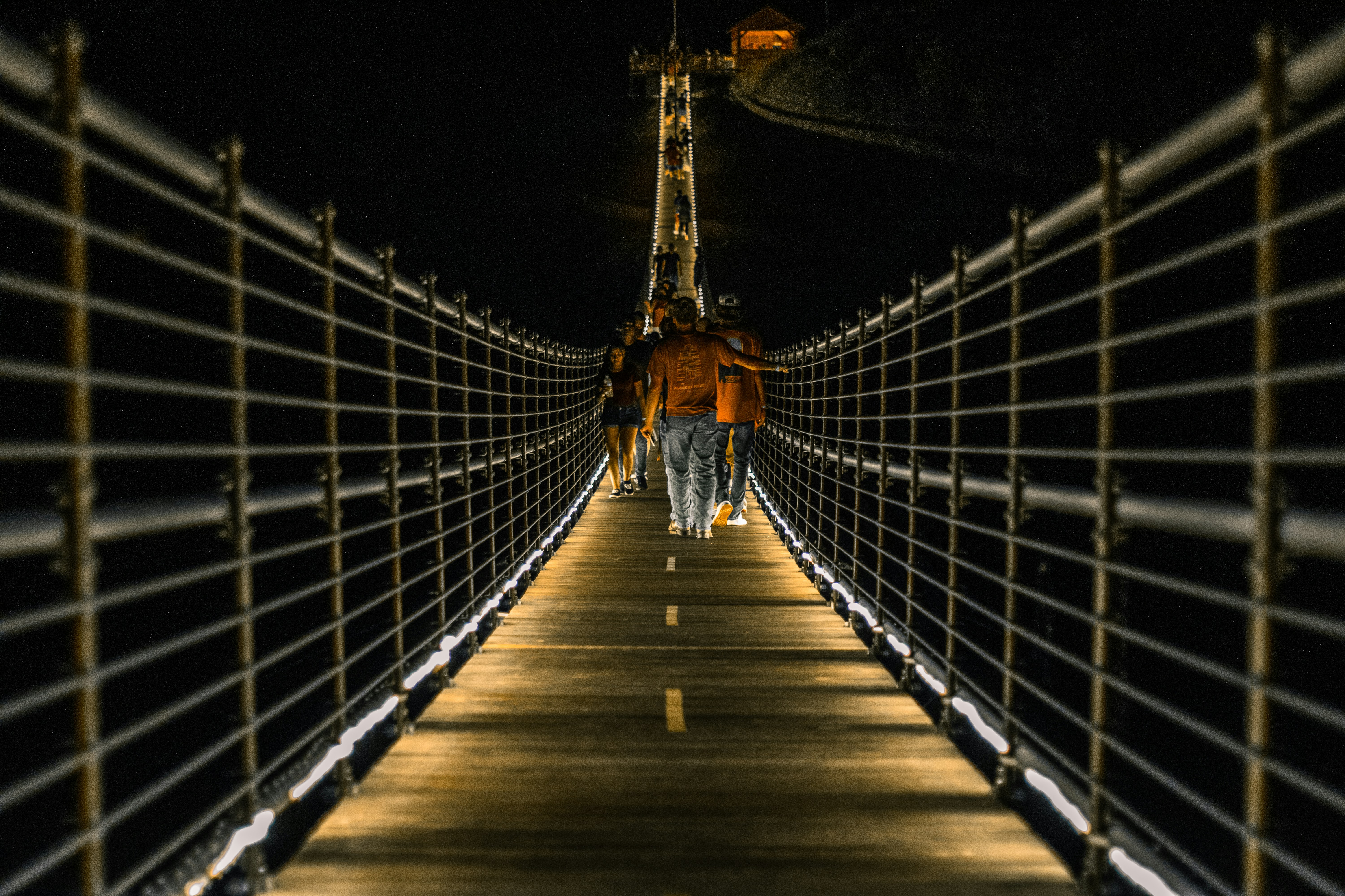 brown wooden bridge during night time
