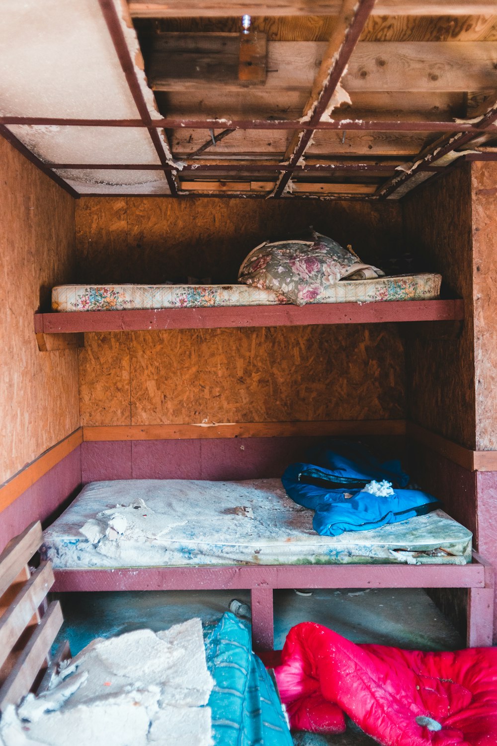 blue textile on brown wooden bunk bed