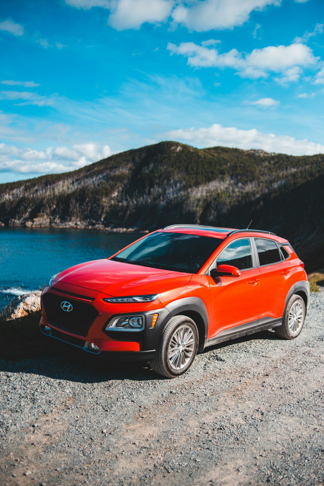 red audi a 4 on a rocky beach