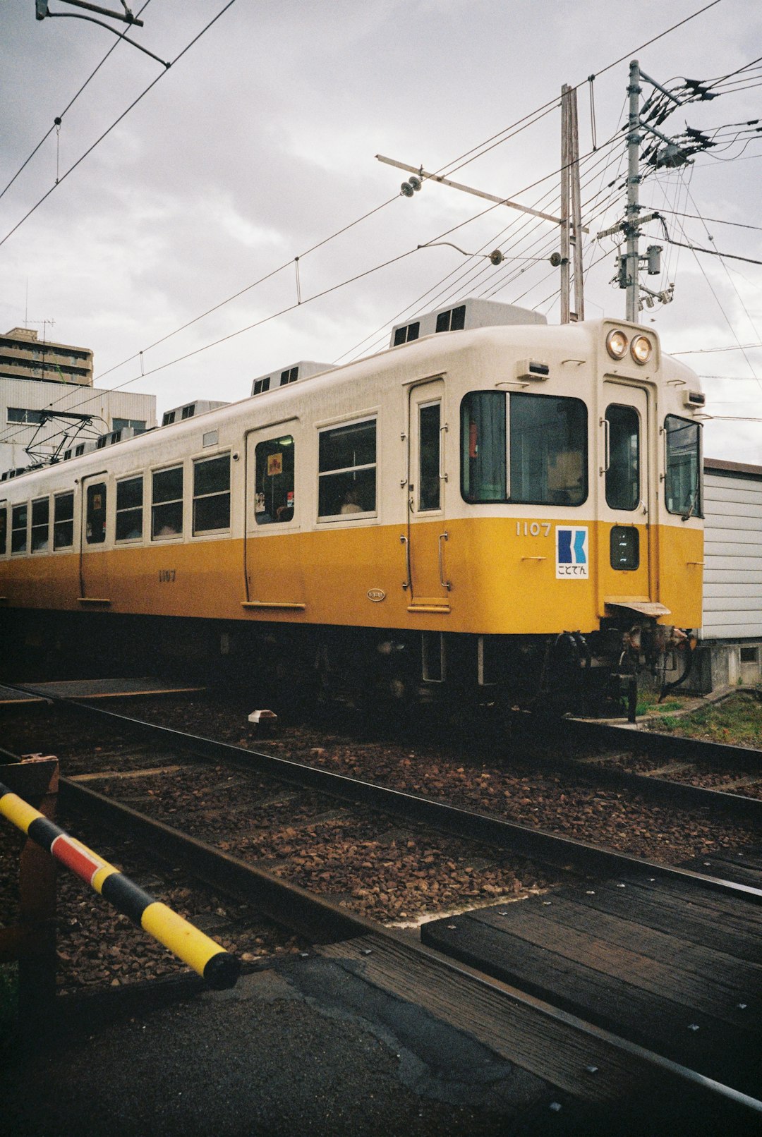 white and yellow train on rail tracks