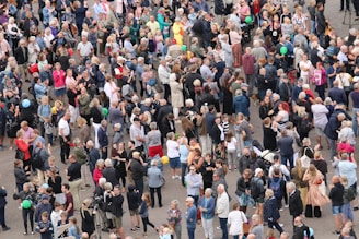A diverse group of people wearing casual and statement clothing outdoors.