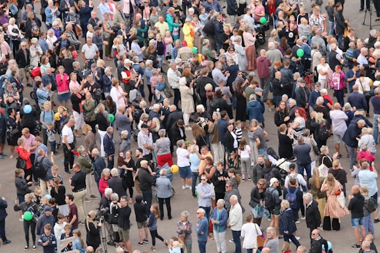 A diverse group of people wearing casual and statement clothing outdoors.