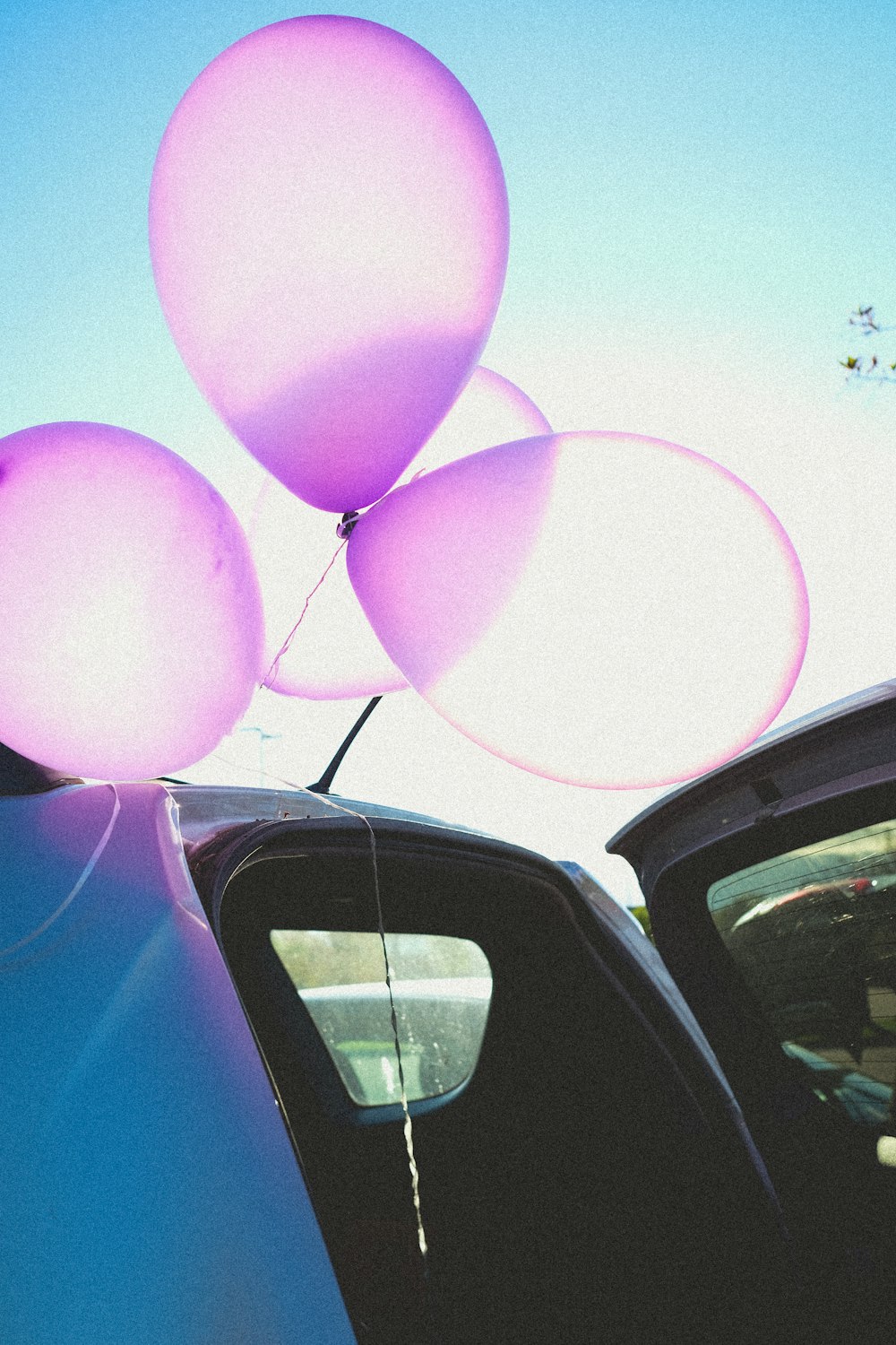 blue car with balloons on top