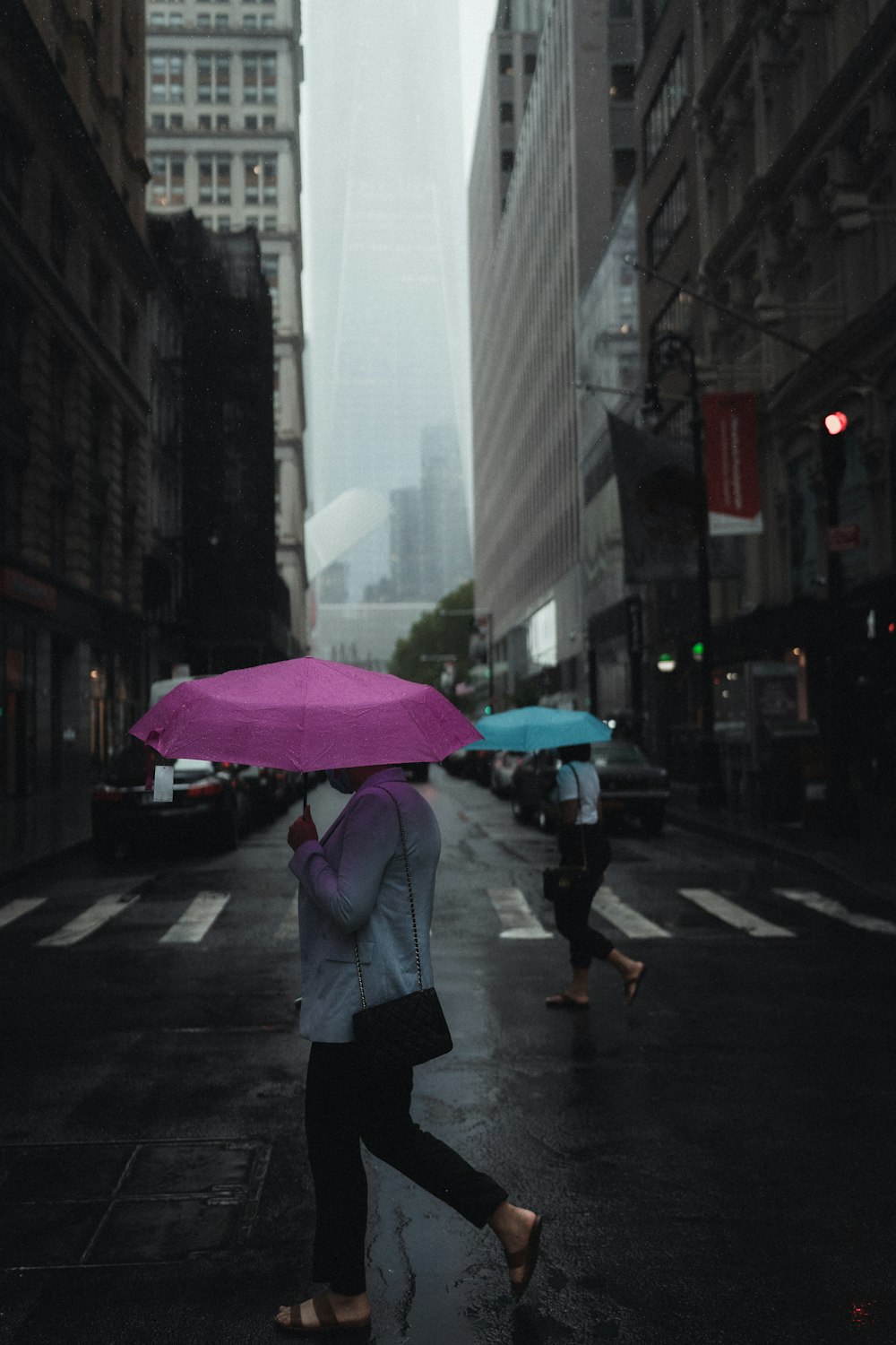 man in white jacket holding pink umbrella