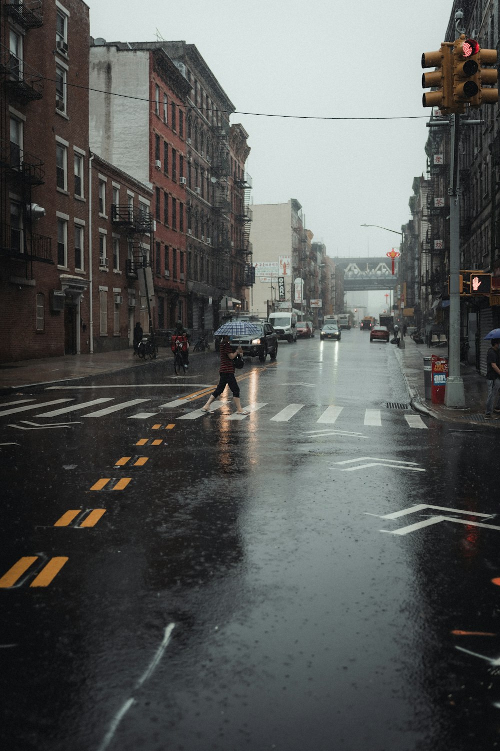 cars on road between buildings during daytime