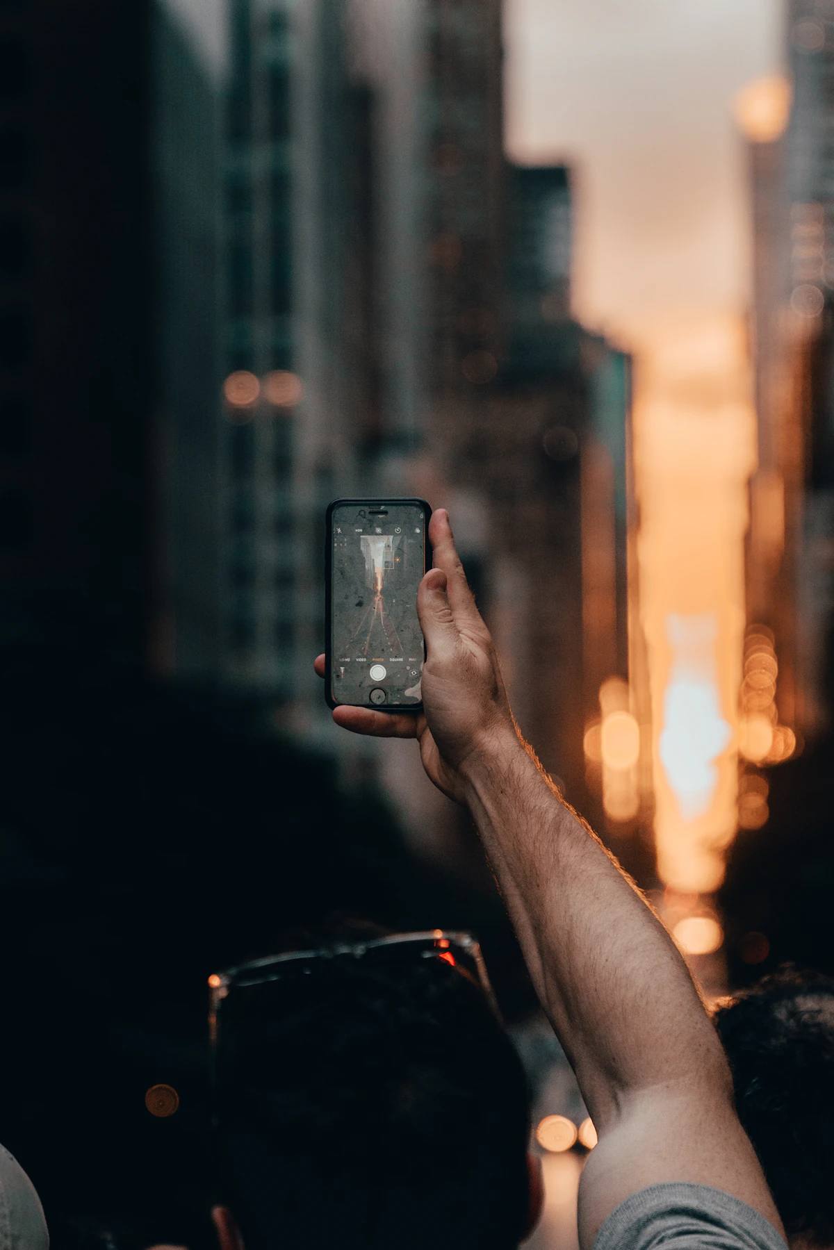 Person holding smartphone in bed at night, illustrating revenge bedtime procrastination