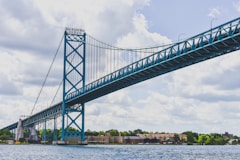 green bridge under white clouds during daytime