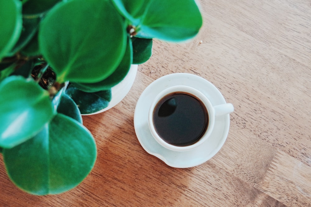 white ceramic mug with black liquid inside