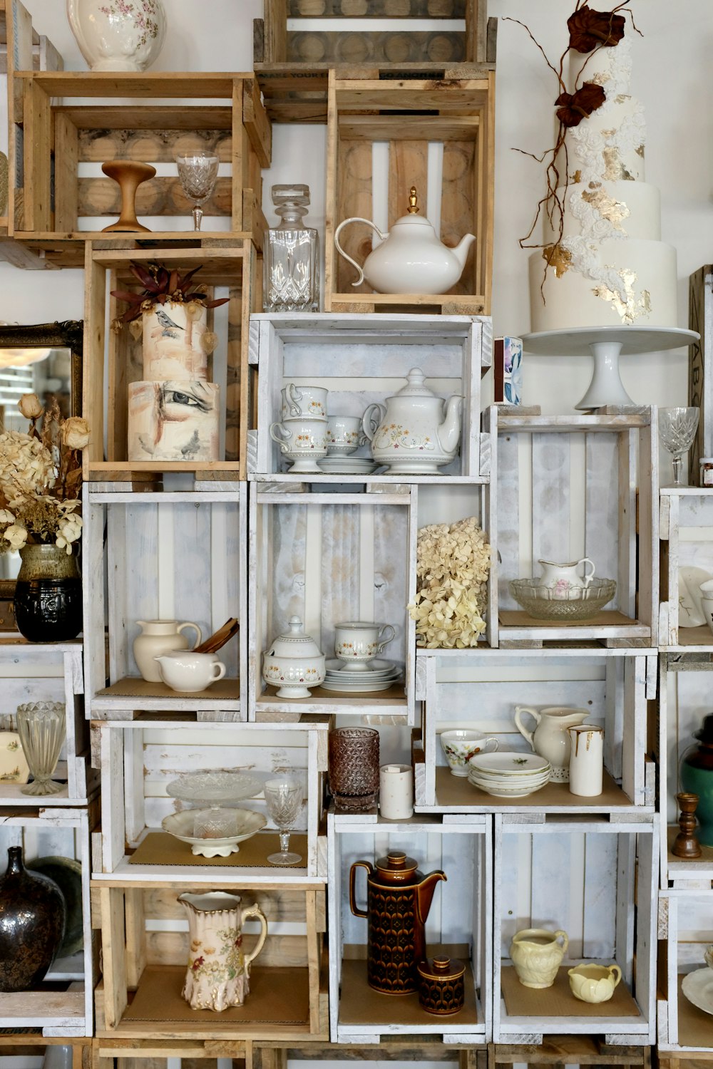 white ceramic tea set on brown wooden shelf