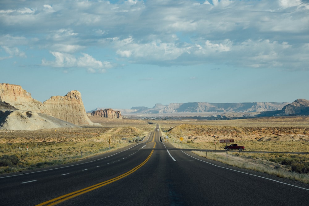 a long stretch of road in the middle of the desert