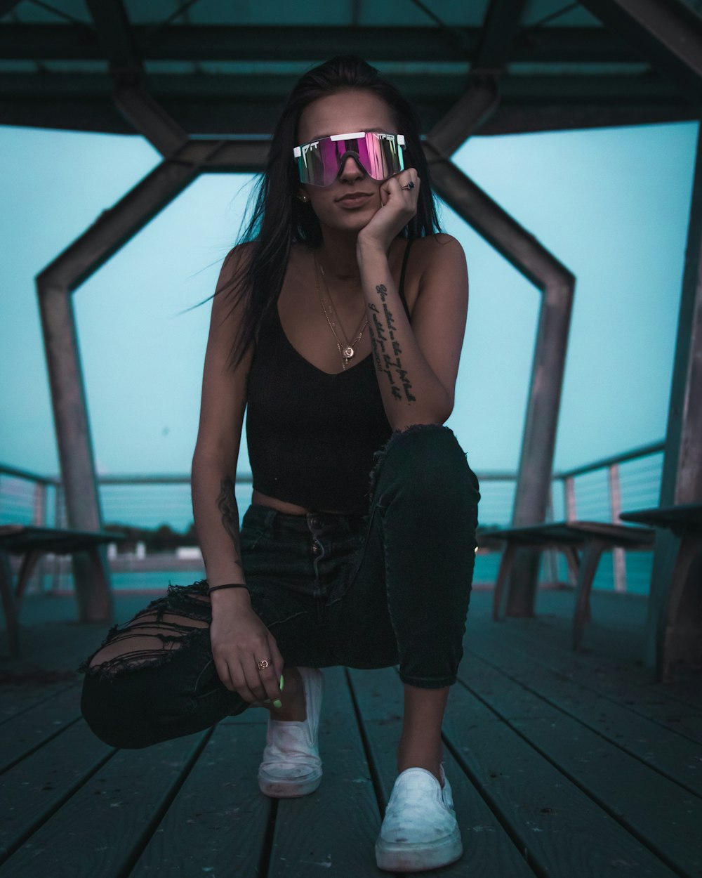 woman in black tank top and black denim jeans wearing sunglasses