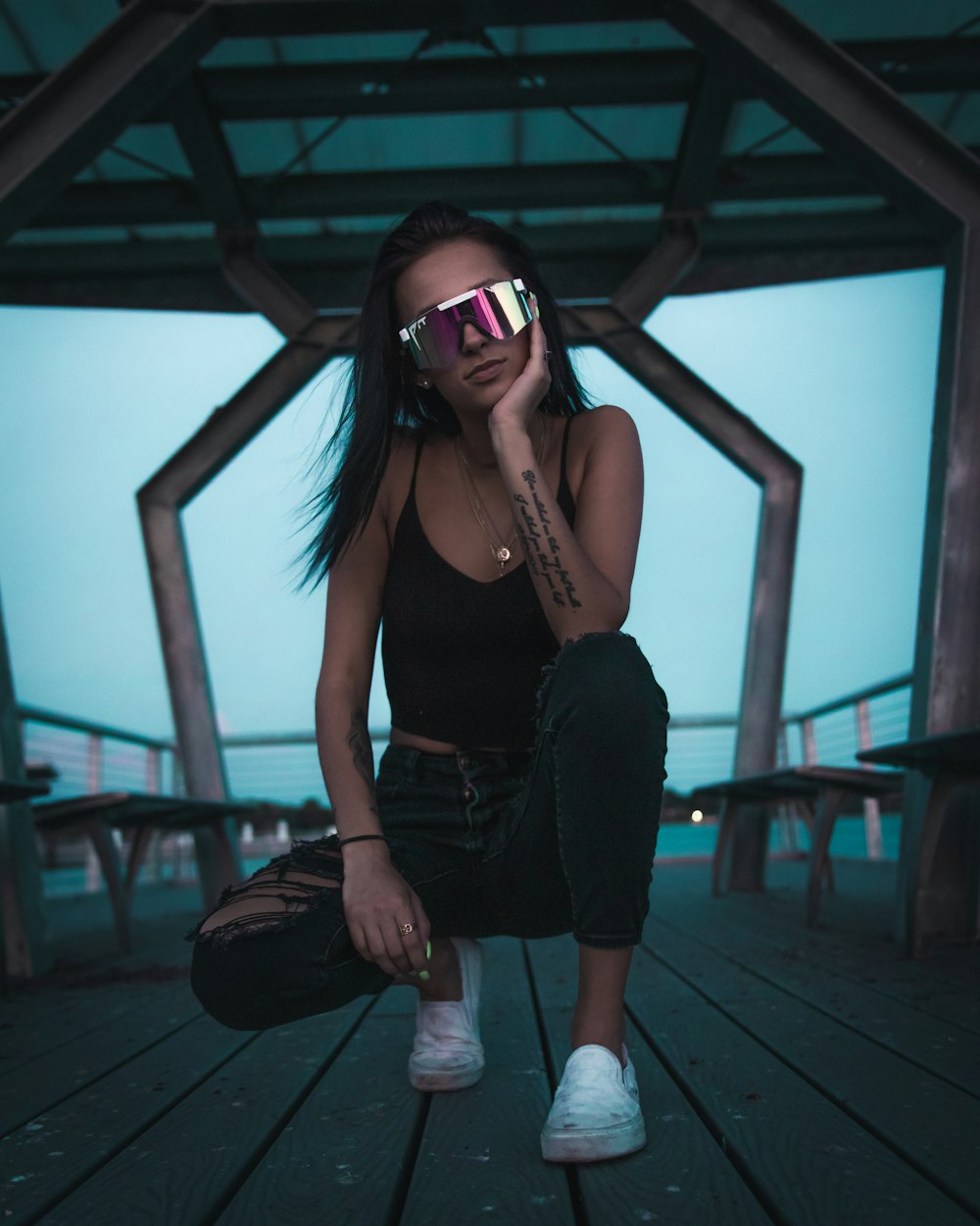 woman in black tank top and black shorts wearing blue goggles