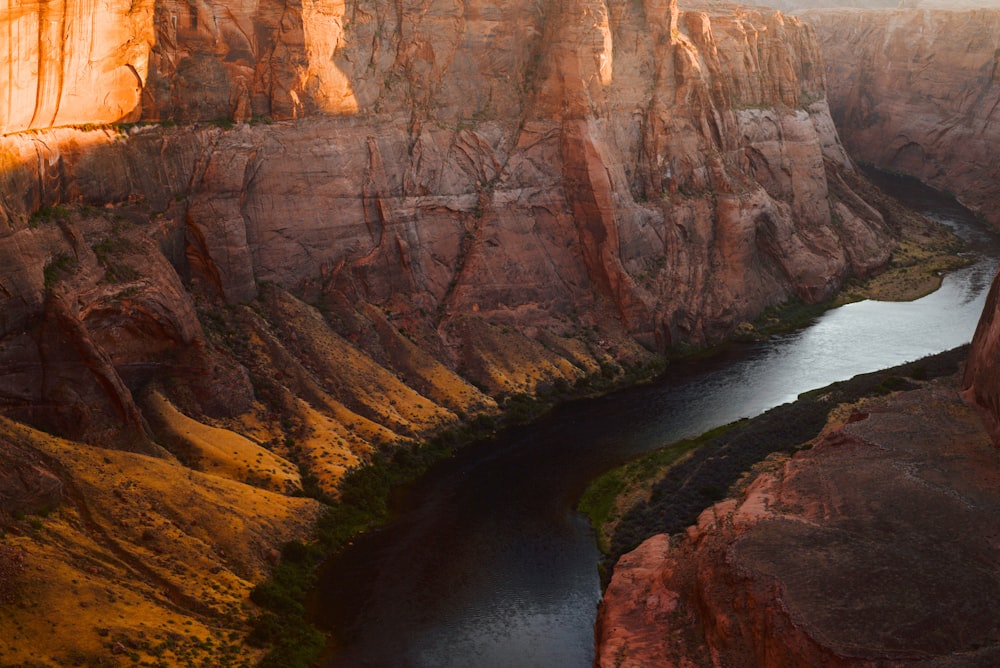 brown rock formation on body of water during daytime