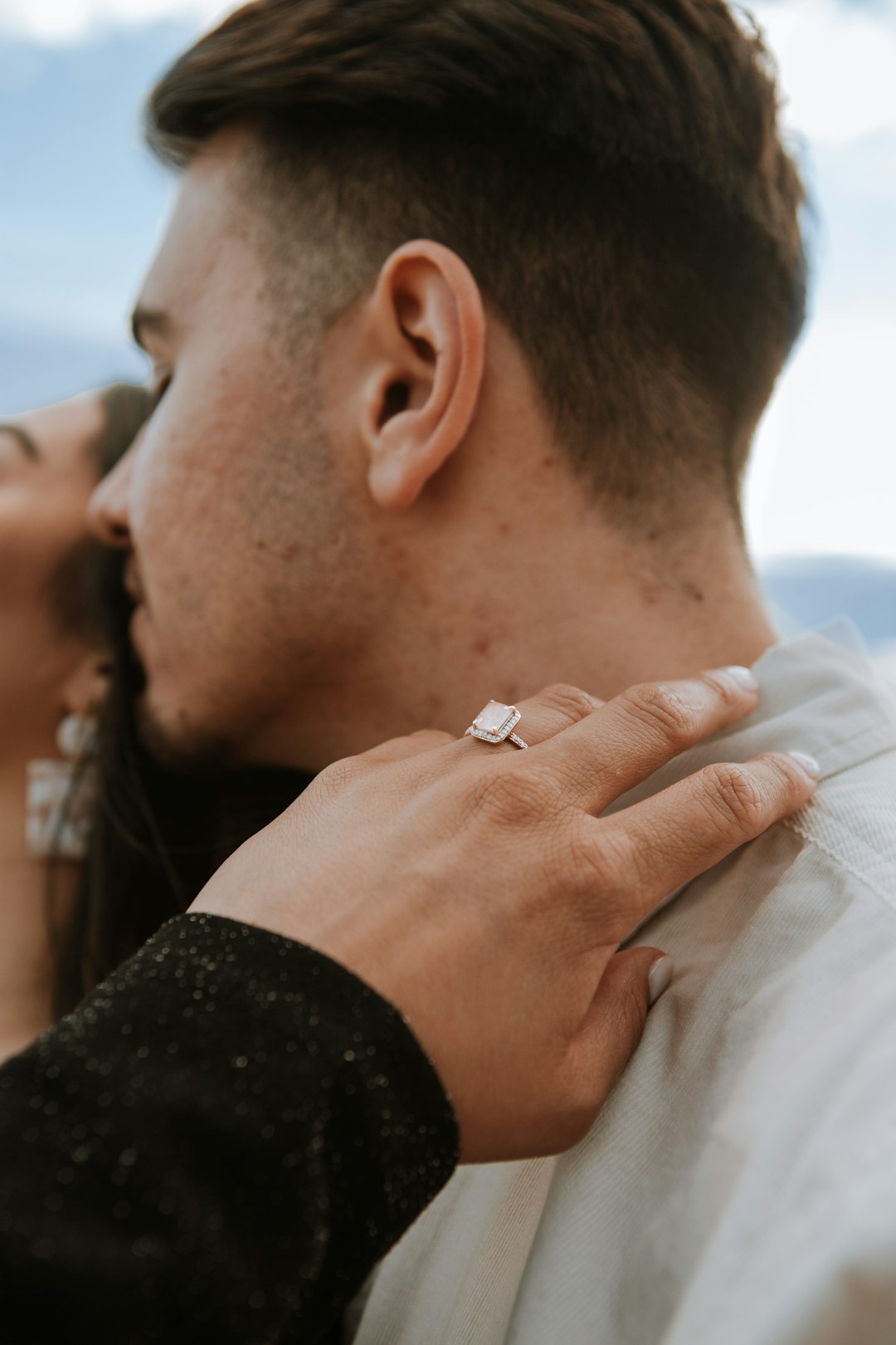 man in black long sleeve shirt holding womans hand