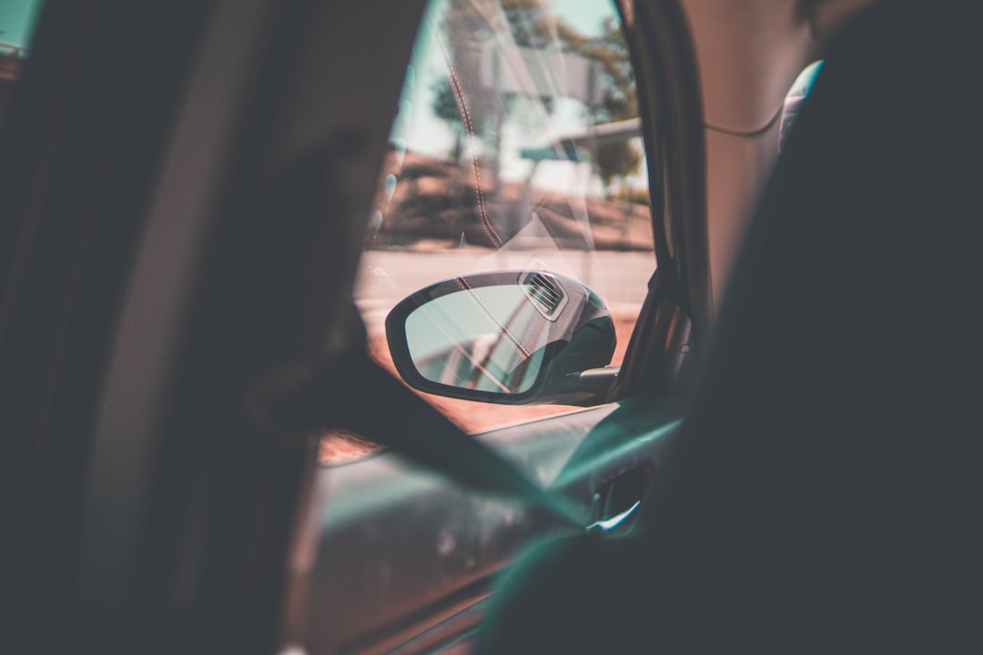 car side mirror with reflection of car