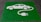 A green painted square on a pavement contains a white stencil of a car with a cable and plug, symbolizing an electric vehicle charging station.