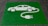 A green painted square on a pavement contains a white stencil of a car with a cable and plug, symbolizing an electric vehicle charging station.
