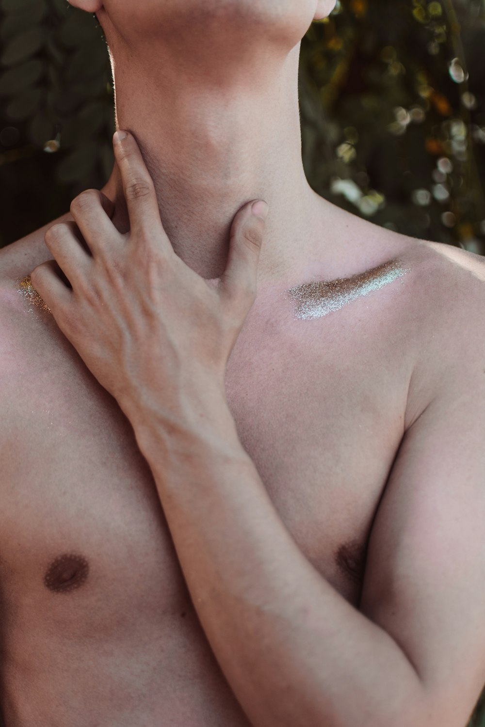 topless woman with purple powder on her face