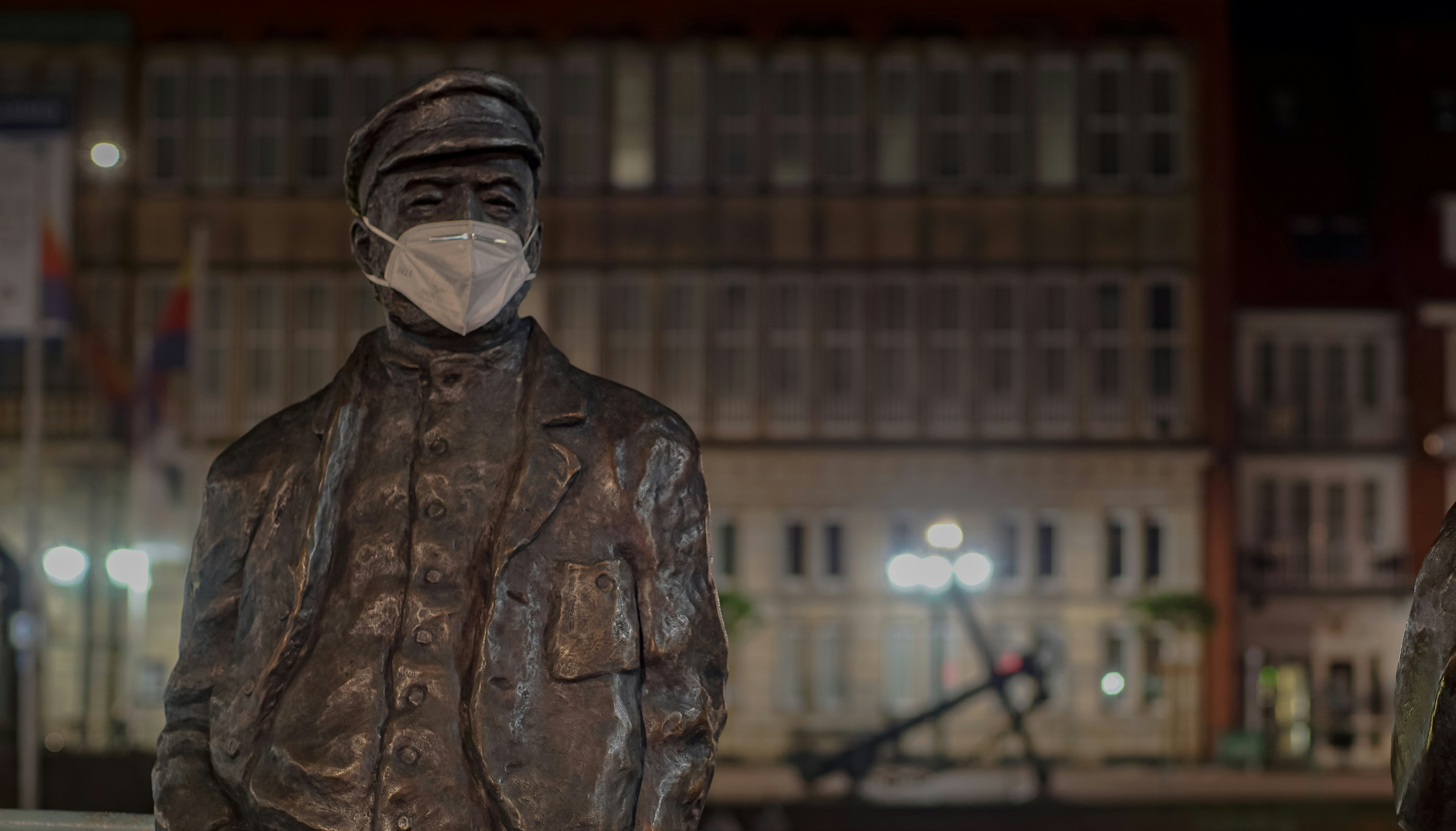 man in brown leather jacket statue