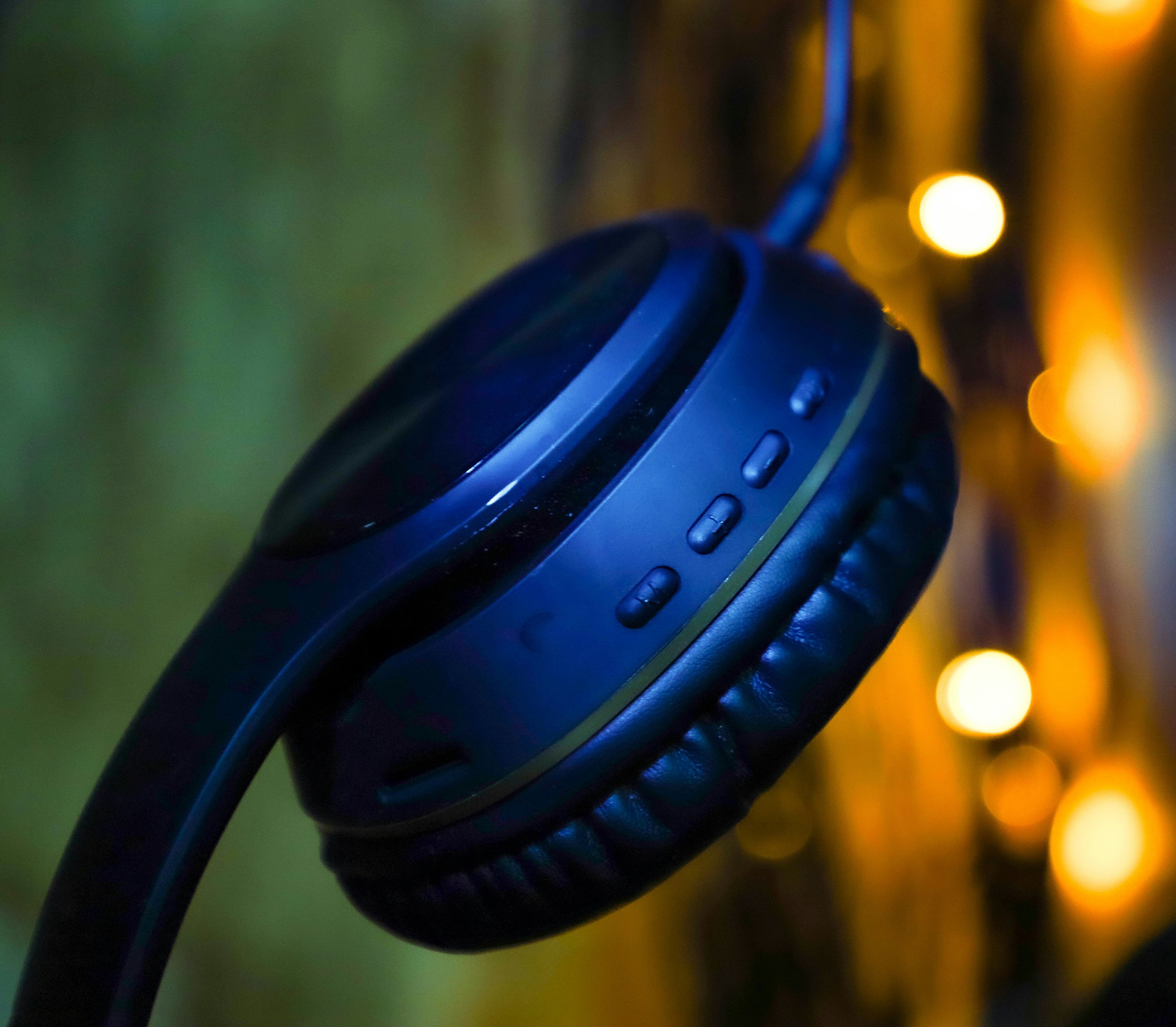 Wireless bluetooth headphones on warm cream background minimal product shot