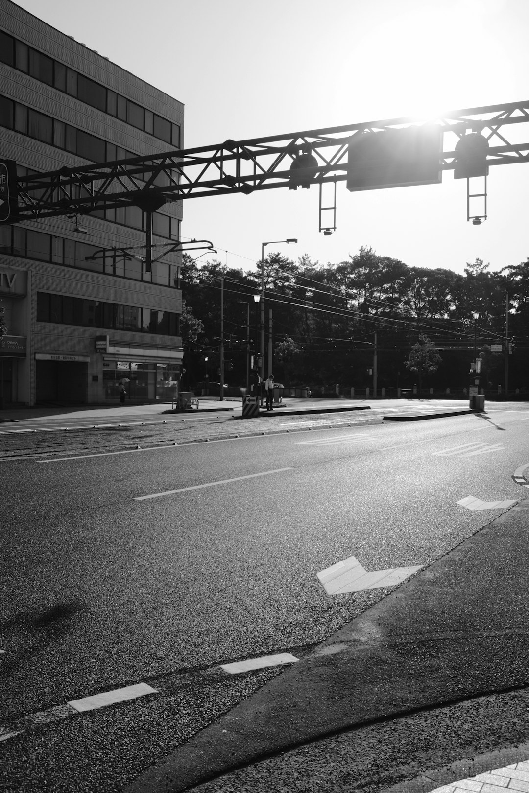 grayscale photo of a road with traffic light