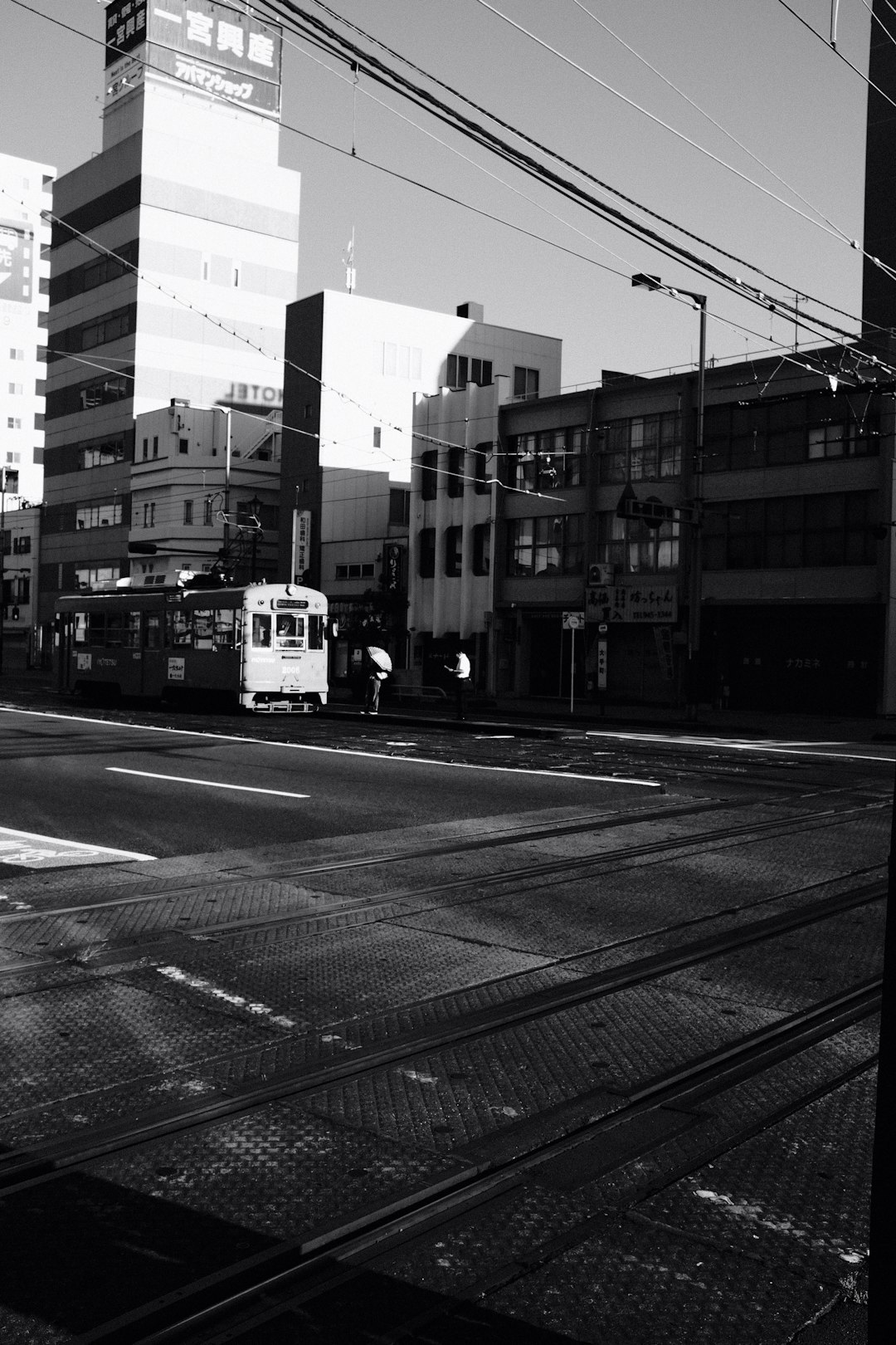white and black tram on road near building during daytime