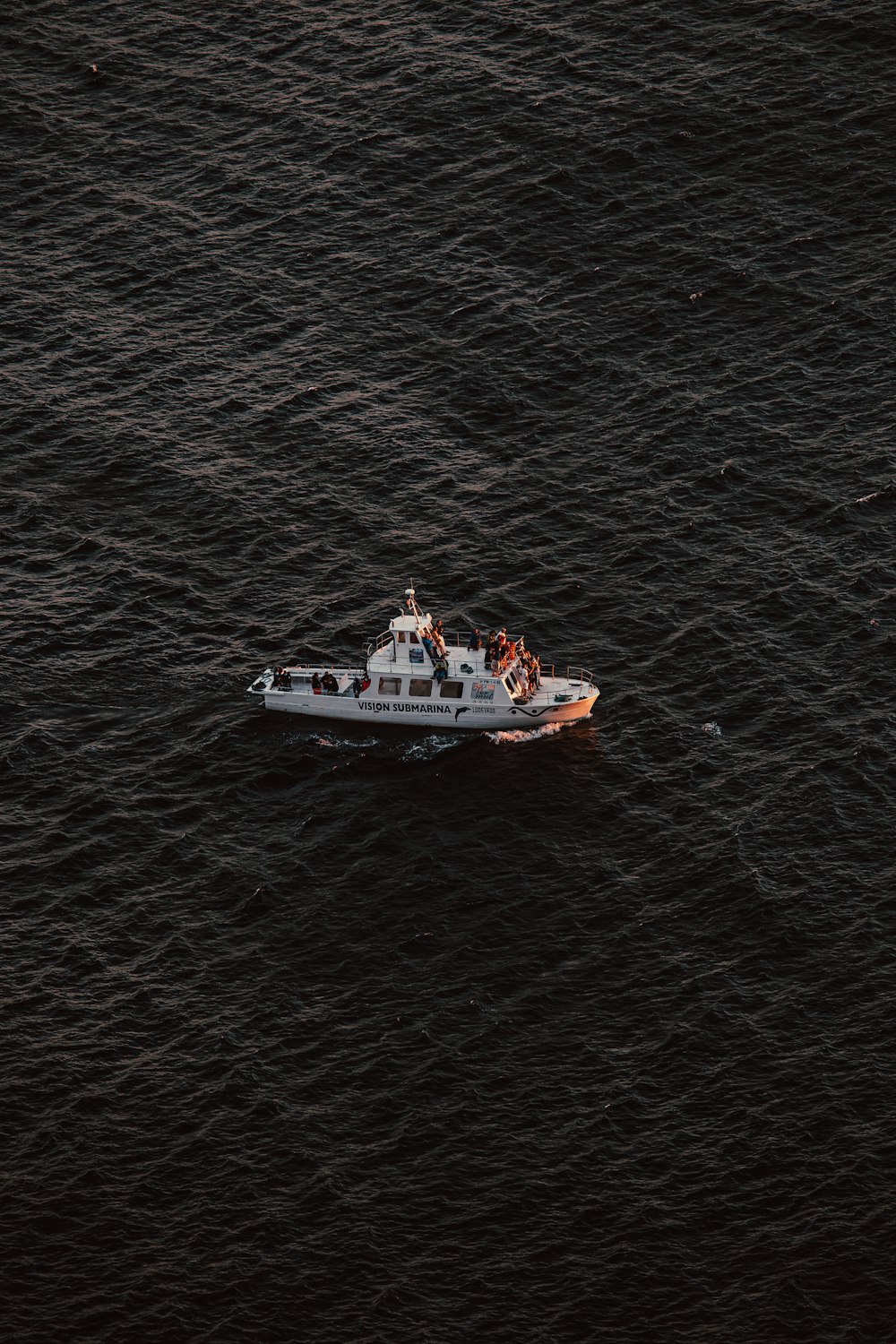 white and red ship on body of water during daytime