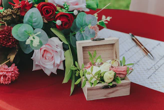 pink and green roses in brown wooden box