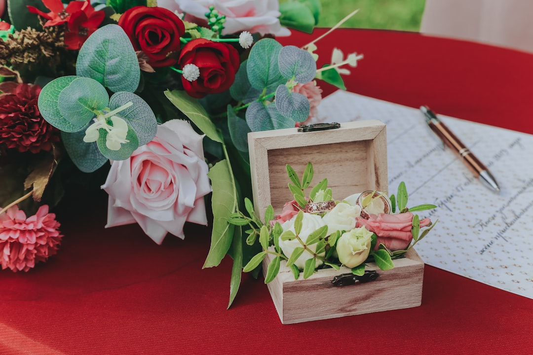 pink and green roses in brown wooden box