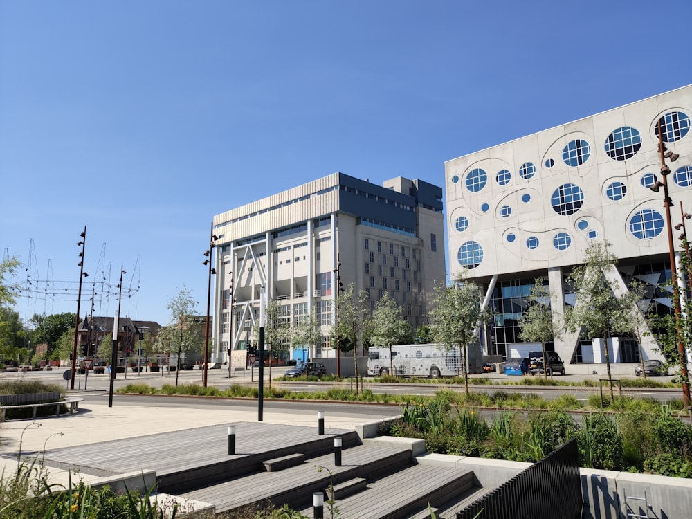 white and blue concrete building near green trees during daytime