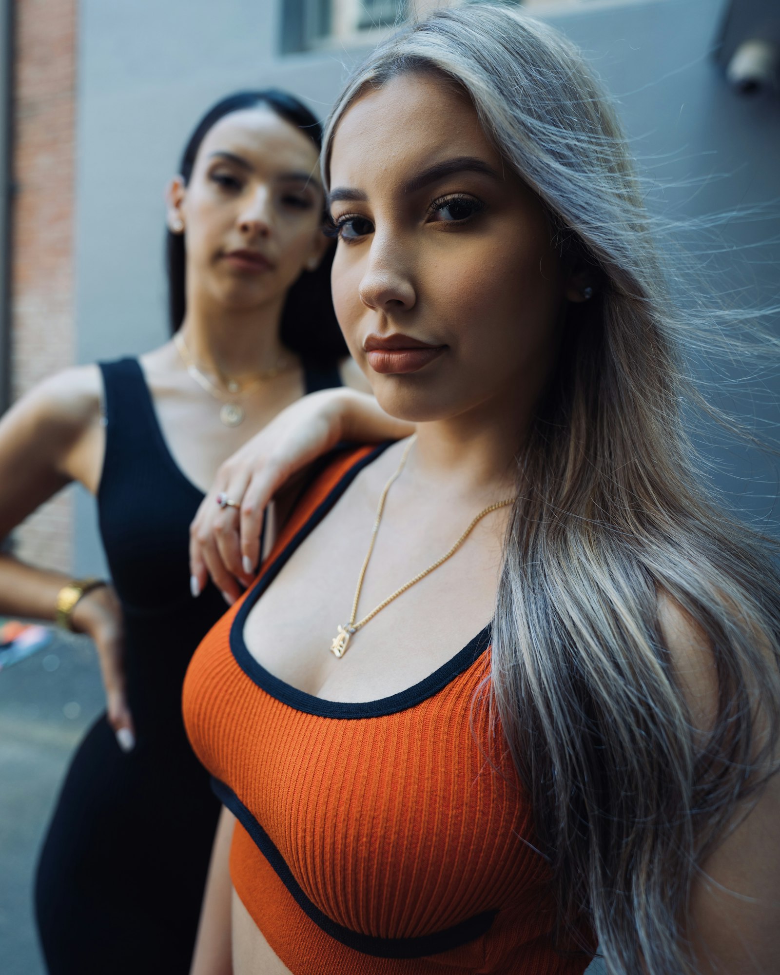 Sony a7R IV + Sony FE 20mm F1.8G sample photo. Woman in orange and photography