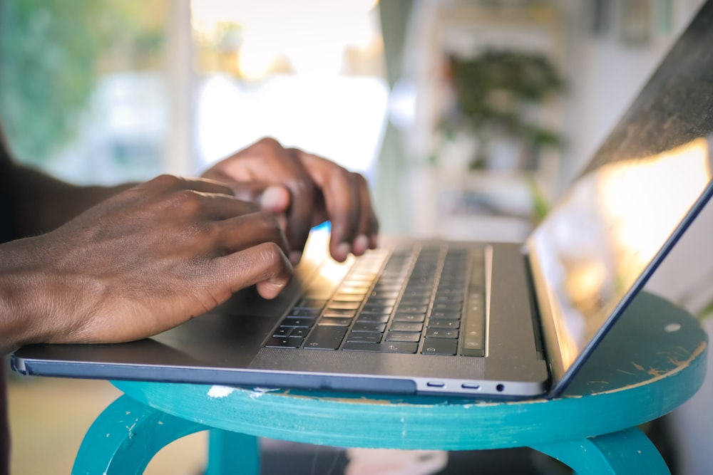 person using silver laptop computer