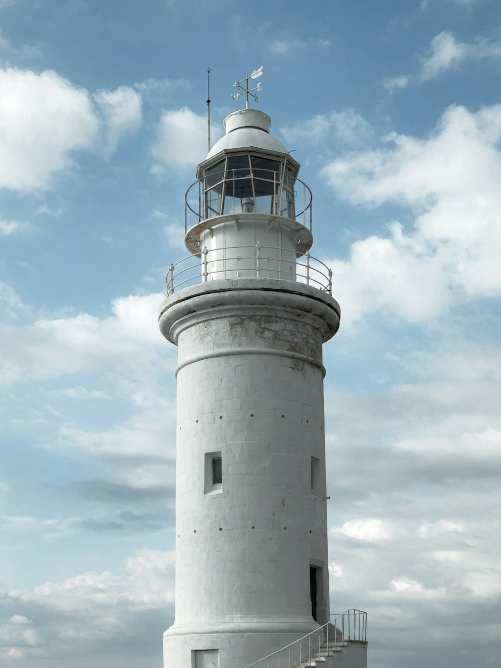 white and black lighthouse under blue sky during daytime