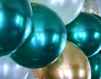 blue and white balloons on white surface