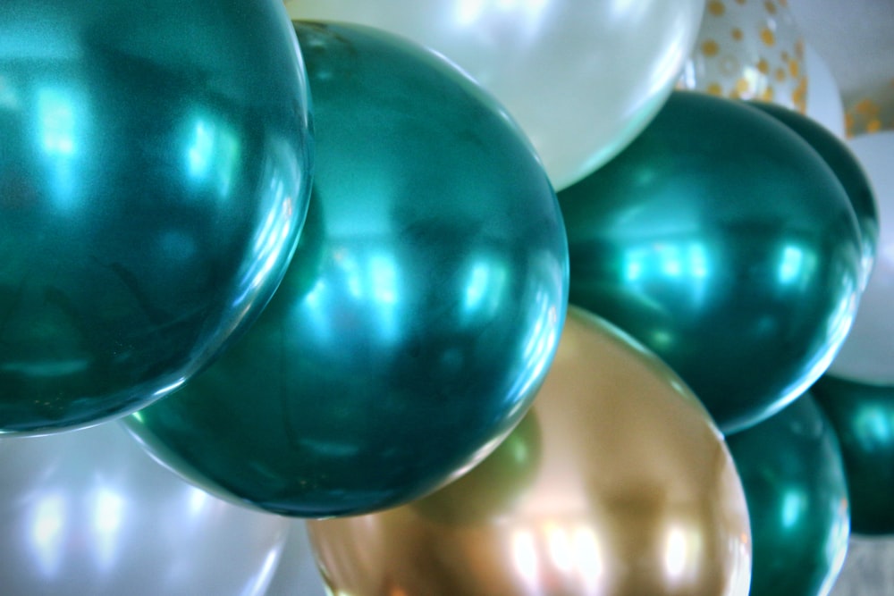 blue and white balloons on white surface