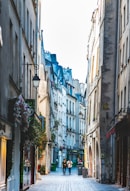 people walking on street between buildings during daytime