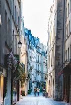 people walking on street between buildings during daytime
