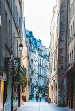 people walking on street between buildings during daytime