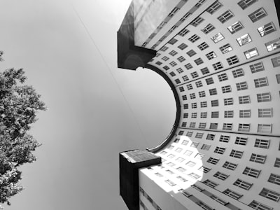 grayscale photo of concrete building constructivism teams background
