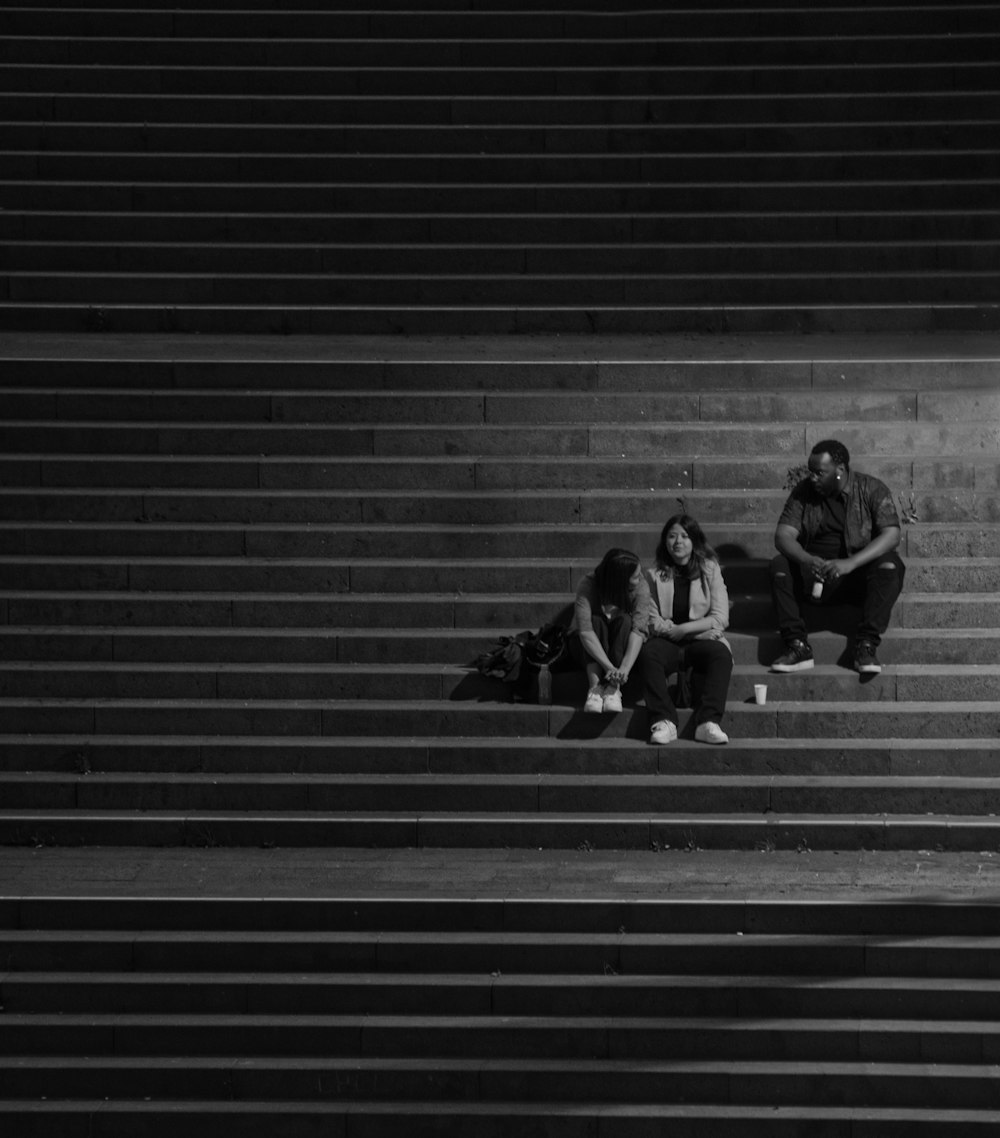 man and woman sitting on stairs