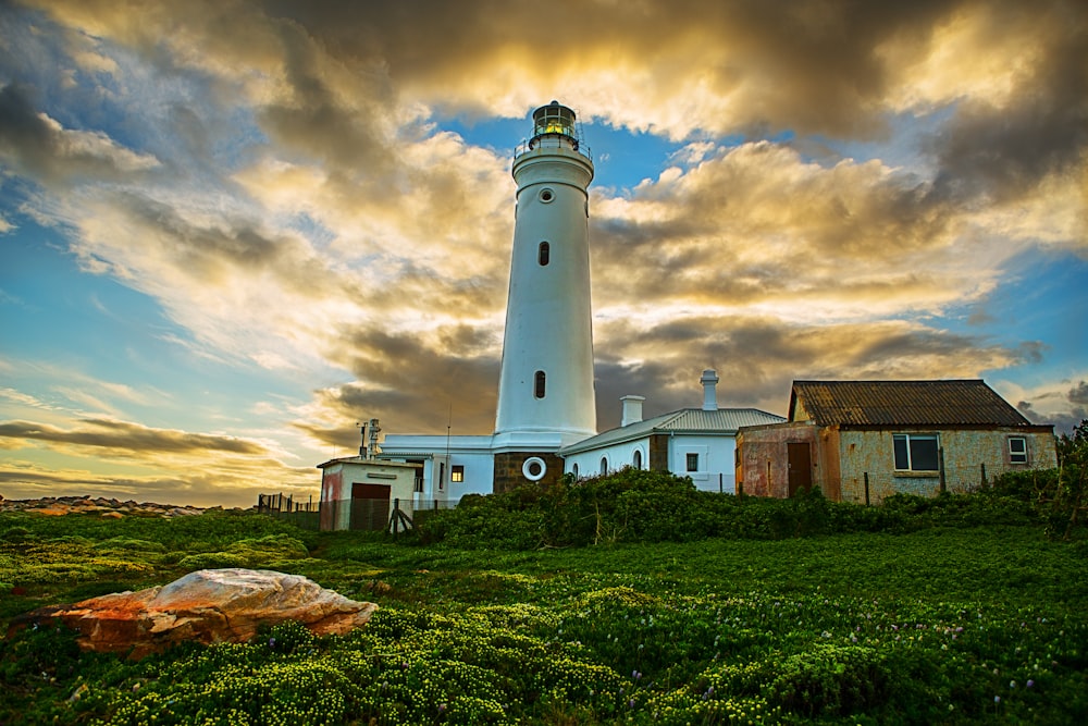 white lighthouse under cloudy sky during daytime