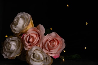 A serene corner with soft lighting, featuring a bouquet of pink roses and golden decor elements.