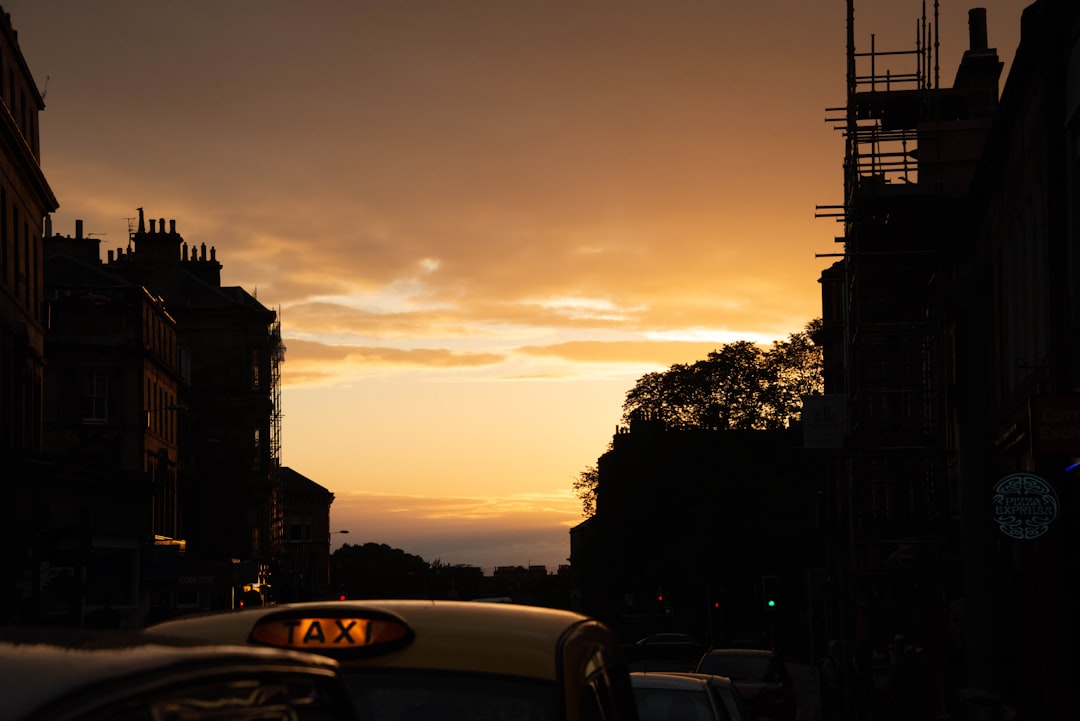 yellow taxi cab on road during sunset