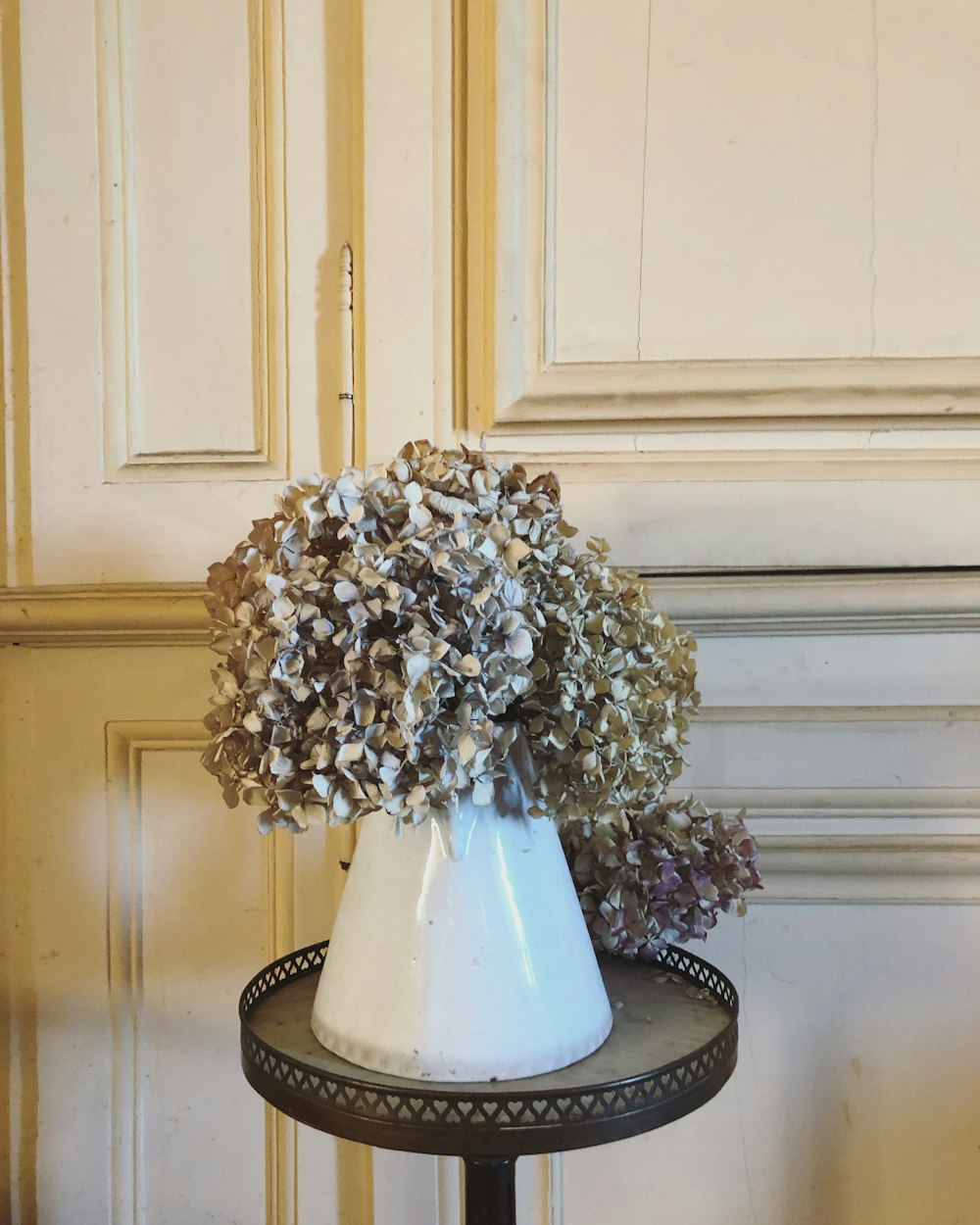 white ceramic vase with brown and white flowers