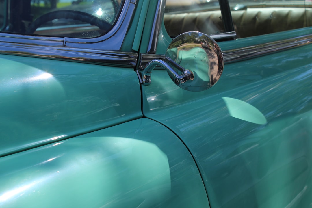 green car side mirror during daytime