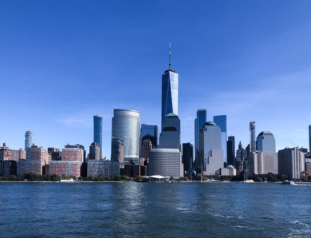 city skyline across body of water during daytime